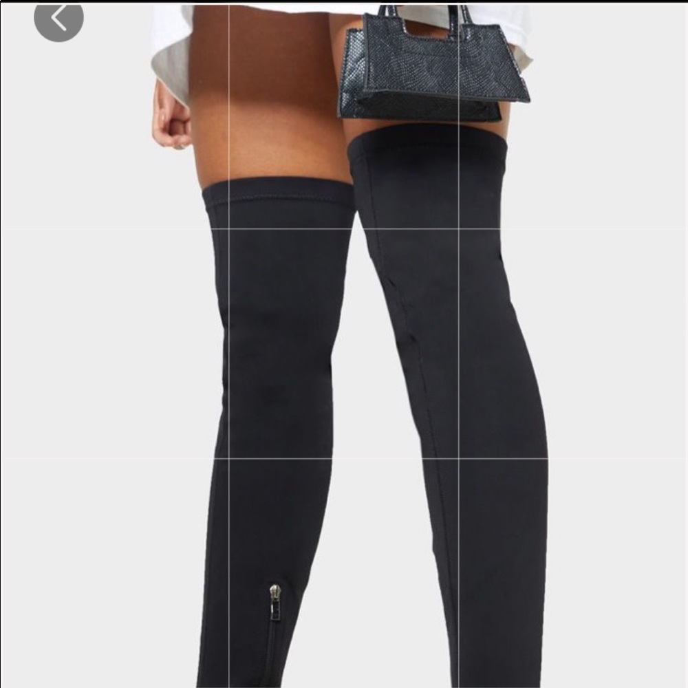 Black thigh high Lycra boots.  Brand new.